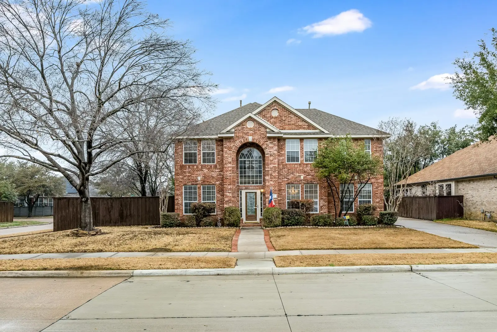 Brick two-story house with many windows